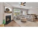 Inviting living room with fireplace, large windows, and plenty of comfortable seating at 738 Woodstock Grove Dr, Woodstock, GA 30188
