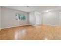Bright living room with hardwood floors and a large window at 1504 Wingate Way, Atlanta, GA 30350
