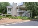 Exterior view of a two-story home with white siding and a stairway to the second level at 1910 Countryside Se Pl, Smyrna, GA 30080