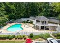Aerial view of the community pool with a sundeck and chairs. Lush green trees surround the pool at 1910 Countryside Se Pl, Smyrna, GA 30080