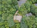 Aerial view of the home nestled amongst mature trees, showcasing its secluded location and neighborhood at 217 Bridgewater Trl, Canton, GA 30115