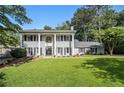 Classical home with a meticulously maintained lawn, surrounded by mature trees at 6300 Blackwater Trl, Atlanta, GA 30328