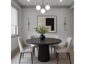 Elegant dining room features a modern chandelier, a round table with seating for four, and a neutral color palette at 4208 Sierra Creek Ct, Hoschton, GA 30548