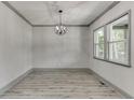 Formal dining room with hardwood floors, modern lighting, and large windows at 4208 Sierra Creek Ct, Hoschton, GA 30548