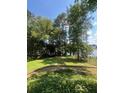 Picturesque backyard with lush greenery, mature trees, and a tranquil view of the lake at 160 Eastlake Nw Pt, Kennesaw, GA 30144
