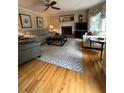 Bright living room featuring hardwood floors, fireplace, and comfortable seating at 160 Eastlake Nw Pt, Kennesaw, GA 30144