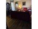 Comfortable living room features hardwood floors, a plush burgundy sofa, and elegant decor at 22 Fairview Dr, Jonesboro, GA 30238