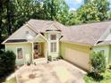 Exterior of a home featuring an attached garage and well-maintained landscaping at 235 Pirkle Ct, Cumming, GA 30040