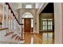 Grand foyer with hardwood floors, staircase, and leaded glass doorway at 6010 Somerset Ct, Suwanee, GA 30024