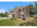 Beautiful home with a lush lawn, complemented by mature trees and brick accents at 1900 Green Oak Cir, Lawrenceville, GA 30043