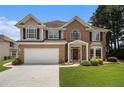 Charming two-story home with a well-maintained lawn and traditional architectural details at 1900 Green Oak Cir, Lawrenceville, GA 30043