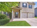Inviting front entrance featuring a covered porch, brick facade, and a two-car attached garage at 219 Sleepy Way, Canton, GA 30114