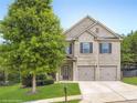 Beautiful two-story brick home with a well-manicured lawn and a two-car attached garage at 219 Sleepy Way, Canton, GA 30114