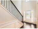 Elegant foyer with hardwood floors, staircase with iron railings, and a bright front door at 219 Sleepy Way, Canton, GA 30114