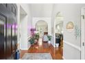 Inviting home foyer with hardwood floors, decor, arched doorways and light, neutral walls at 1010 Capella Creek Way, Grayson, GA 30017