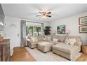 Comfortable living room featuring a sectional sofa, hardwood flooring, and natural light at 2703 Carolyn Se Dr, Smyrna, GA 30080