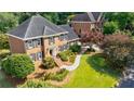 Beautiful brick home boasts manicured landscaping and a inviting walkway at 5004 Haralson Sw Way, Lilburn, GA 30047