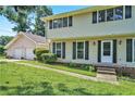 Two-story home with black shutters, an attached two-car garage and a simple, landscaped front yard at 5419 Ahyoka Dr, Morrow, GA 30260
