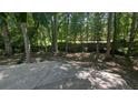 Concrete patio area provides ample space for outdoor entertaining among mature trees at 3618 Prescot Way, Douglasville, GA 30135