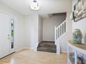 Inviting entryway with hardwood floors and staircase that leads to the upper level at 5841 Cobalt Dr, Powder Springs, GA 30127