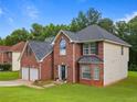 This attractive home has a brick facade, a two-car garage, and a well-kept lawn at 5841 Cobalt Dr, Powder Springs, GA 30127