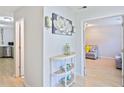 Neutral hallway with lovely decor leading to the kitchen and living room at 5841 Cobalt Dr, Powder Springs, GA 30127
