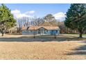 Inviting one-story home with mature trees and a spacious front yard at 900 Stone Lea Trce, Oxford, GA 30054