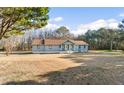 Cozy one-story home with a large front yard and a mix of mature trees at 900 Stone Lea Trce, Oxford, GA 30054