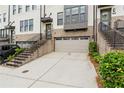 Townhome featuring attached garage with painted garage door and landscaping at 2118 Iverson Se Dr, Smyrna, GA 30080