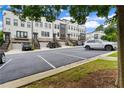 View of the front of the townhomes showcasing ample parking at 2118 Iverson Se Dr, Smyrna, GA 30080