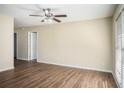 Bright living room with hardwood floors, a modern ceiling fan, and natural light from the window at 1380 Colony Hill Ct, Stone Mountain, GA 30083