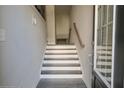 Bright foyer with white trim stairs, gray wood flooring, and a modern design at 2247 Pink Hawthorn Dr, Buford, GA 30518