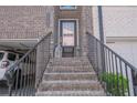 Welcoming entryway with brick steps, decorative lanterns, and a secure front door at 2247 Pink Hawthorn Dr, Buford, GA 30518