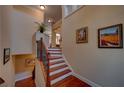 Elegant staircase with wood treads, iron railings, and neutral wall decor at 1622 Rivergreen Se Bnd # 26, Atlanta, GA 30339