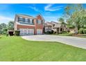 Expansive front lawn complements this beautiful brick home with a three-car garage at 3819 Courson St, Marietta, GA 30066