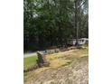 A unique property with a manufactured home and hay bale terracing amidst lush greenery at 6394 Shore Dr, Douglasville, GA 30135