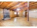 Spacious living room features wood-paneled walls, brick fireplace, and hardwood floors at 504 N Little Victoria Rd, Woodstock, GA 30189