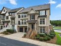 Charming townhome showcasing its brick and siding exterior, a small front yard, and an attached two-car garage at 1165 Laurel Se Pl, Smyrna, GA 30080