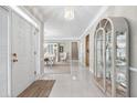 Bright foyer with marble tile floors, a chandelier, and an open view of the adjacent dining room at 1297 Hadaway Trl, Lawrenceville, GA 30043