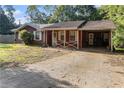 Charming single story home with a covered parking area and a spacious front yard at 3953 Dalhouise Ln, Decatur, GA 30034