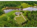 Overhead view of estate including the house, yard, pond, and driveway for a picturesque setting at 833 Hines Rd, Moreland, GA 30259