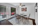 Bright dining area featuring a glass-top table, decorative rug, and sliding doors to an outdoor deck at 3464 Navaho Se Trl, Smyrna, GA 30080