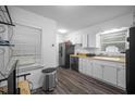 Bright kitchen features white cabinets and countertops, updated appliances, and vinyl flooring at 3464 Navaho Se Trl, Smyrna, GA 30080