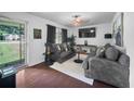 Cozy living room with dark wood floors, neutral paint, and modern furnishings at 3464 Navaho Se Trl, Smyrna, GA 30080