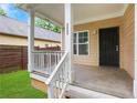 Inviting covered front porch with classic architectural details and weathered wood deck at 2005 Chicago Nw Ave, Atlanta, GA 30314