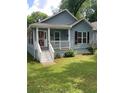 Cozy blue house with a well-manicured lawn, front porch, and classic design elements at 1833 Phillips Ave, East Point, GA 30344