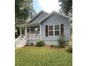 Charming blue house with a well-manicured lawn and a welcoming front porch at 1833 Phillips Ave, East Point, GA 30344
