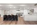 Spacious kitchen with stainless steel appliances, a center island, and hardwood floors at 700 Park Regency Ne Pl # 1605, Atlanta, GA 30326