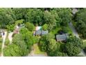 An aerial view showing the property, lush trees, swimming pool, and neighboring houses at 865 Old Creek Trl, Atlanta, GA 30328