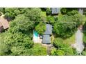 Aerial view of the property with its private pool, well-maintained lawn, and surrounding lush greenery at 865 Old Creek Trl, Atlanta, GA 30328